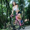 Full length of woman riding bicycle on road